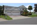 Beautiful two-story house featuring a spacious three-car garage, lovely landscaping, and a well-maintained lawn at 2543 Chapala Dr, Kissimmee, FL 34746
