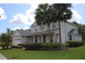 Attractive two-story home boasting well-manicured landscaping, a covered entry, and a neatly maintained lawn at 2543 Chapala Dr, Kissimmee, FL 34746