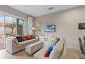 Cozy living room with comfortable seating, sliding glass doors, and neutral décor at 2630 Sunrise Shores Dr, Kissimmee, FL 34747
