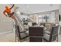 Open-concept living space featuring a dining area, staircase, and modern kitchen at 2630 Sunrise Shores Dr, Kissimmee, FL 34747