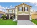 Charming two-story home featuring a two-car garage, a screened-in porch, and a well-maintained lawn at 2657 Bullion Loop, Sanford, FL 32771
