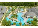 Aerial view of a community pool area with multiple pools, a lazy river, cabanas, and lush landscaping, perfect for relaxation at 3180 Paradox Cir # 304, Kissimmee, FL 34746