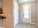 Bright foyer with tile flooring, a decorative glass front door, and neutral wall color at 3651 Nw 56Th Ave, Ocala, FL 34482