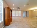 Spacious living room featuring tile flooring, a ceiling fan, and ample natural light at 3651 Nw 56Th Ave, Ocala, FL 34482