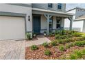 Inviting front yard of this lovely home, complete with a cozy porch, pavers and landscape at 4007 Meandering Bay Dr, Apopka, FL 32712