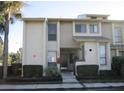 Exterior shot showing the multi-level townhome with neutral tones and manicured landscaping for a welcoming aesthetic at 4372 Middlebrook Rd # 3, Orlando, FL 32811