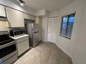Efficient kitchen featuring stainless steel appliances, tile flooring, and ample storage, creating a functional space at 4372 Middlebrook Rd # 3, Orlando, FL 32811