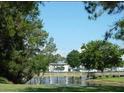Picturesque view of the community pond with lush green trees providing a serene and natural environment at 4372 Middlebrook Rd # 3, Orlando, FL 32811