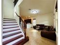 Open-concept living space with tiled floors, staircase and dark cabinets at 4900 Beach Blvd, Orlando, FL 32803
