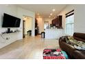 Spacious living room featuring an open layout with tiled floors and dark cabinetry at 4900 Beach Blvd, Orlando, FL 32803