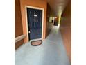 Exterior entryway featuring welcome mat and blue door at 5116 Conroy Rd # 411, Orlando, FL 32811