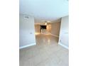Open living room with tile flooring, neutral walls, and a view of the kitchen at 5116 Conroy Rd # 411, Orlando, FL 32811