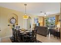 Open concept living and dining area with tile flooring and plenty of natural light at 7660 Comrow St # 203, Kissimmee, FL 34747