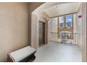 Inviting hallway with neutral walls, arched doorway, and a view of the outdoors at 8168 Boat Hook Loop # 201/718, Windermere, FL 34786