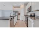 Bright kitchen featuring stainless steel appliances and a center island with a sink at 865 Citrus Reserve Blvd, Davenport, FL 33837
