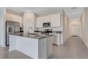Modern kitchen featuring stainless steel appliances and a center island at 865 Citrus Reserve Blvd, Davenport, FL 33837