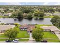 Aerial view of a waterfront home in a residential neighborhood with lush greenery and scenic views at 930 Chickadee Dr, Port Orange, FL 32127
