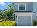 Attached garage of a charming home with lush landscaping with a beautifully maintained exterior at 934 Rock Harbor Ave, Orlando, FL 32828