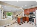 Modern kitchen with stainless steel appliances, seamlessly flowing into the dining and living areas at 934 Rock Harbor Ave, Orlando, FL 32828
