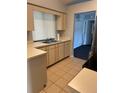Functional kitchen features tile floors, laminate countertops, and an undermounted double basin sink at 1029 Norwood Dr, Deltona, FL 32725