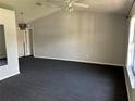 Bright and airy living room with vaulted ceiling, updated flooring, and neutral paint at 1029 Norwood Dr, Deltona, FL 32725