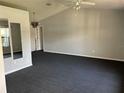 Spacious living room featuring vaulted ceilings, neutral walls, large mirrors, and plenty of natural light at 1029 Norwood Dr, Deltona, FL 32725