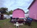 Backyard shed with a utility table next to the pink home at 1038 26Th St, Orlando, FL 32805