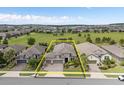 Aerial view of home showcasing landscaping, lawn and neighborhood location at 1212 Zeek Ridge St, Clermont, FL 34715
