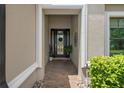 Inviting front entryway with tiled floor and decorative details on the front door and sidelights at 1212 Zeek Ridge St, Clermont, FL 34715