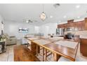 Open-concept living space featuring a dining area, a kitchen with modern appliances, and a comfortable living room at 12216 Prairie Plantation Way, Orlando, FL 32824