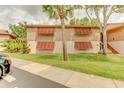 A condo exterior with shuttered windows, well-maintained landscaping, and a sidewalk at 150 Wax Myrtle Woods Ct # 3D, Deltona, FL 32725