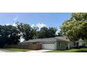Charming single-story home featuring a two-car garage and a wooden privacy fence at 1501 Delaware Ave, St Cloud, FL 34769