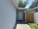 Front door is sheltered by a roof overhang and a small front walkway with privacy fence at 1501 Delaware Ave, St Cloud, FL 34769