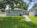 Well-maintained home featuring a green lawn and inviting walkway to the entrance at 1501 Delaware Ave, St Cloud, FL 34769