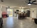 The open floor plan showcases a spacious living room with tile flooring and a modern island kitchen at 1501 Delaware Ave, St Cloud, FL 34769