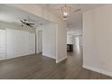 Spacious living room featuring wood floors, and an open floor plan leading into the kitchen at 15229 Evergreen Oak Loop, Winter Garden, FL 34787