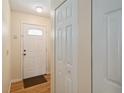 Bright entryway featuring a white front door with glass detail and wood flooring at 1591 Pendleton St, Deltona, FL 32725