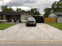 Driveway with paver stones on a home with light colored exterior and dark roof, black fence in back at 170 N Fairfax Ave, Winter Springs, FL 32708