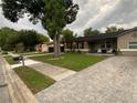 Well-maintained single Gathering home with green lawn, sidewalk, mature trees and a paved driveway at 170 N Fairfax Ave, Winter Springs, FL 32708