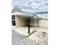 Attached carport featuring covered parking and adjacent fenced area, providing outdoor privacy at 1815 Townhall Ln # 1815, Orlando, FL 32807