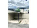 Attached carport offering covered parking and convenient access to the home's fenced outdoor area at 1815 Townhall Ln # 1815, Orlando, FL 32807