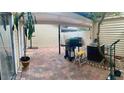 Large outdoor patio with grill and shaded area at 1815 Townhall Ln # 1815, Orlando, FL 32807