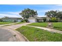 View of a well-kept single Gathering home on a quiet street with a lush green lawn at 1840 Orange View Ct, Kissimmee, FL 34746