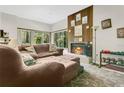 Cozy living room featuring a warm fireplace and large windows with picturesque views at 2142 Woodbridge Rd, Longwood, FL 32779