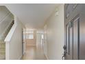 Bright foyer with tile flooring, staircase, and views into adjacent living spaces at 2901 Ashford Park Pl, Oviedo, FL 32765