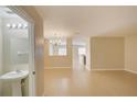 Open-concept living space featuring tile floors and a view of a dining area with chandelier at 2901 Ashford Park Pl, Oviedo, FL 32765