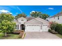 Charming home with a manicured lawn, brick driveway, and a three-car garage perfect for a Gathering at 2922 Reef Knot Pl, Winter Park, FL 32792