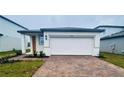 Charming single-story home featuring a two-car garage and a well-maintained brick driveway at 29783 Anahid Dr, Leesburg, FL 34748