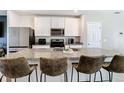 Kitchen featuring stainless appliances, granite countertops, with bar stool seating at 29783 Anahid Dr, Leesburg, FL 34748