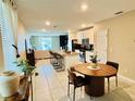 Open-concept layout combining the kitchen, dining area, and living room creating an inviting atmosphere at 29783 Anahid Dr, Leesburg, FL 34748
